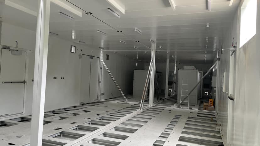 Equipment bases and maintenance aisle after double-bay assembly